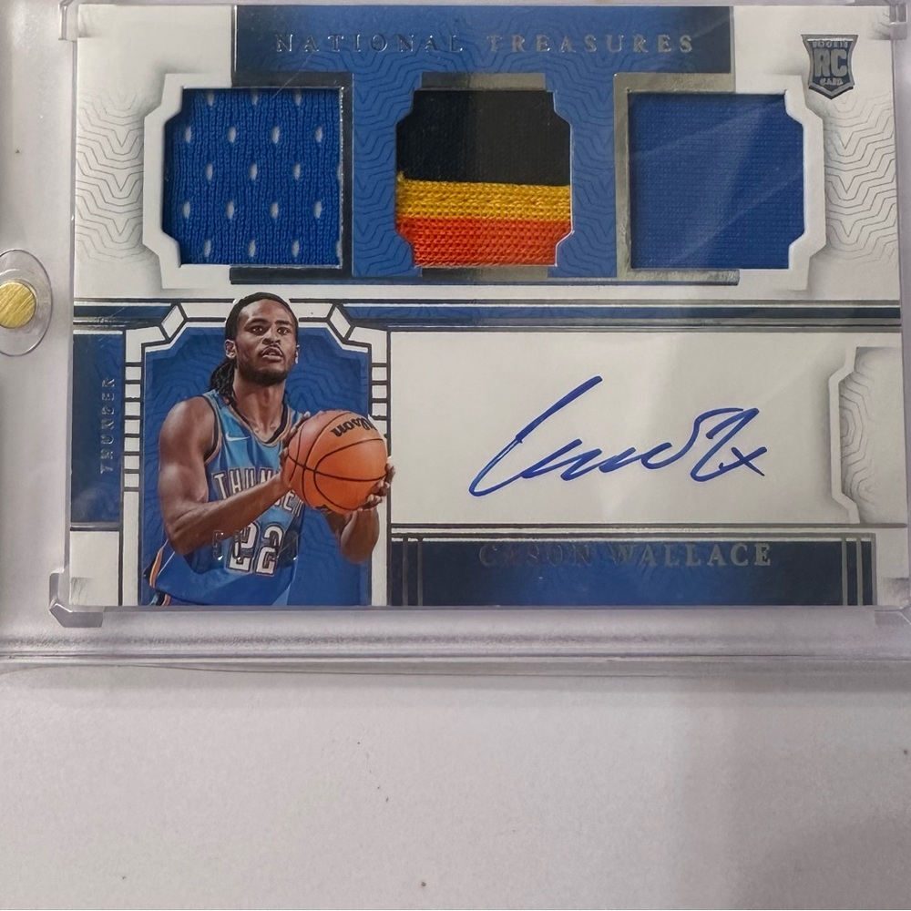 Trading Card Blue and Black National Treasures Cason Wallace auto Jersey serial